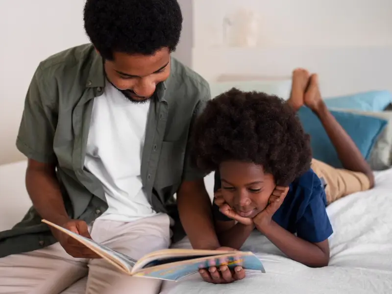 Father reading a bedtime story with his son