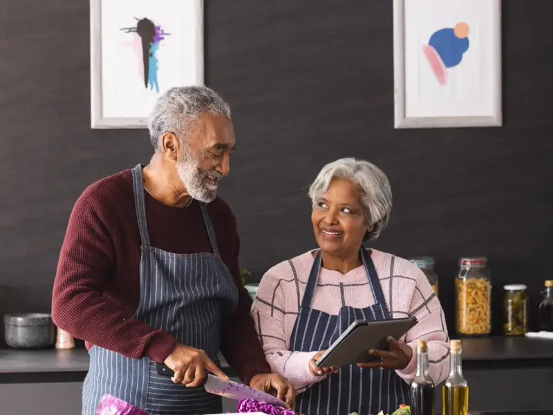 Older couple cooking together at home